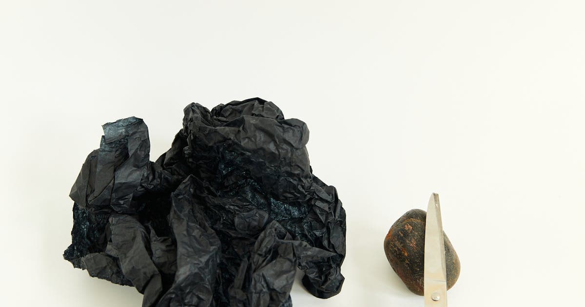 Artistic still life of rock, paper, and scissors representing the classic game